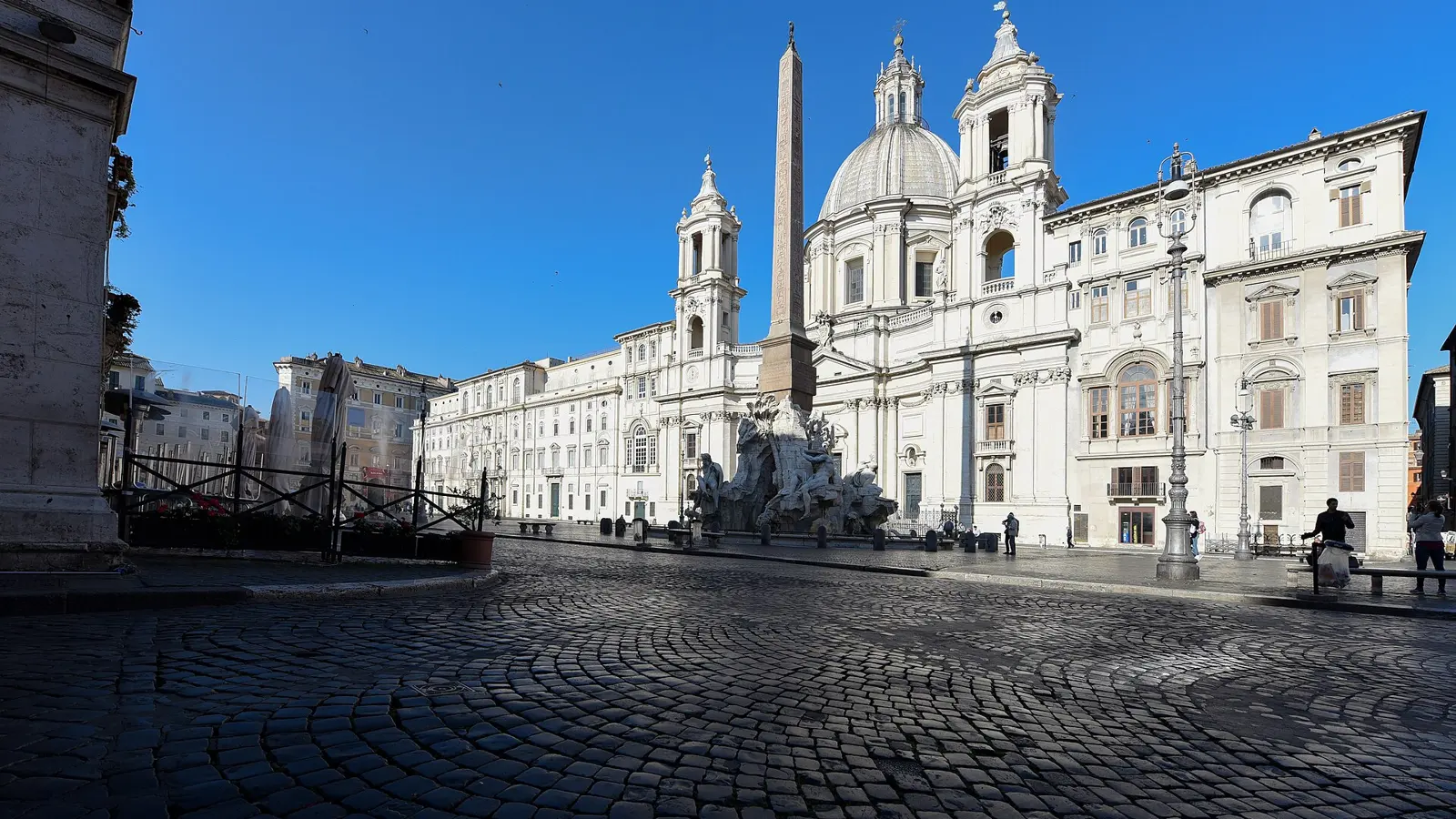 A rooftop terrace above Piazza Navona in Rome at blue hour, opera dinner rome